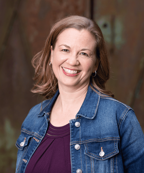 Dr Kristina Lewis in front of Iron Door